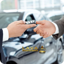 Dealership handing car key to customer at Lava Automotive